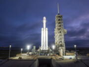 A Falcon Heavy rocket is seen Dec. 28 in Cape Canaveral, Fla. With more than 5 million pounds of liftoff thrust the Heavy will be capable of lifting super-size satellites into orbit and sending spacecraft to the moon, Mars and beyond.