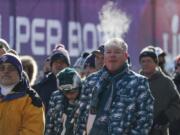 FILE In this Feb. 4, 2018 file photo fans brave cold temperatures as they wait to get into U.S. Bank Stadium before the NFL Super Bowl 52 football game between the Philadelphia Eagles and the New England Patriots Sunday, Feb. 4, 2018, in Minneapolis. The extreme cold that settled over Minneapolis during the Super Bowl has some wondering if the NFL’s marquee event will ever return. Despite some complaints about the weather, many who attended say it wasn’t a negative. The NFL has used the Super Bowl as a reward for municipalities that pump public money into new venues. The next four Super Bowls will be held at warm-weather sites, all of them with new or recently renovated stadiums.