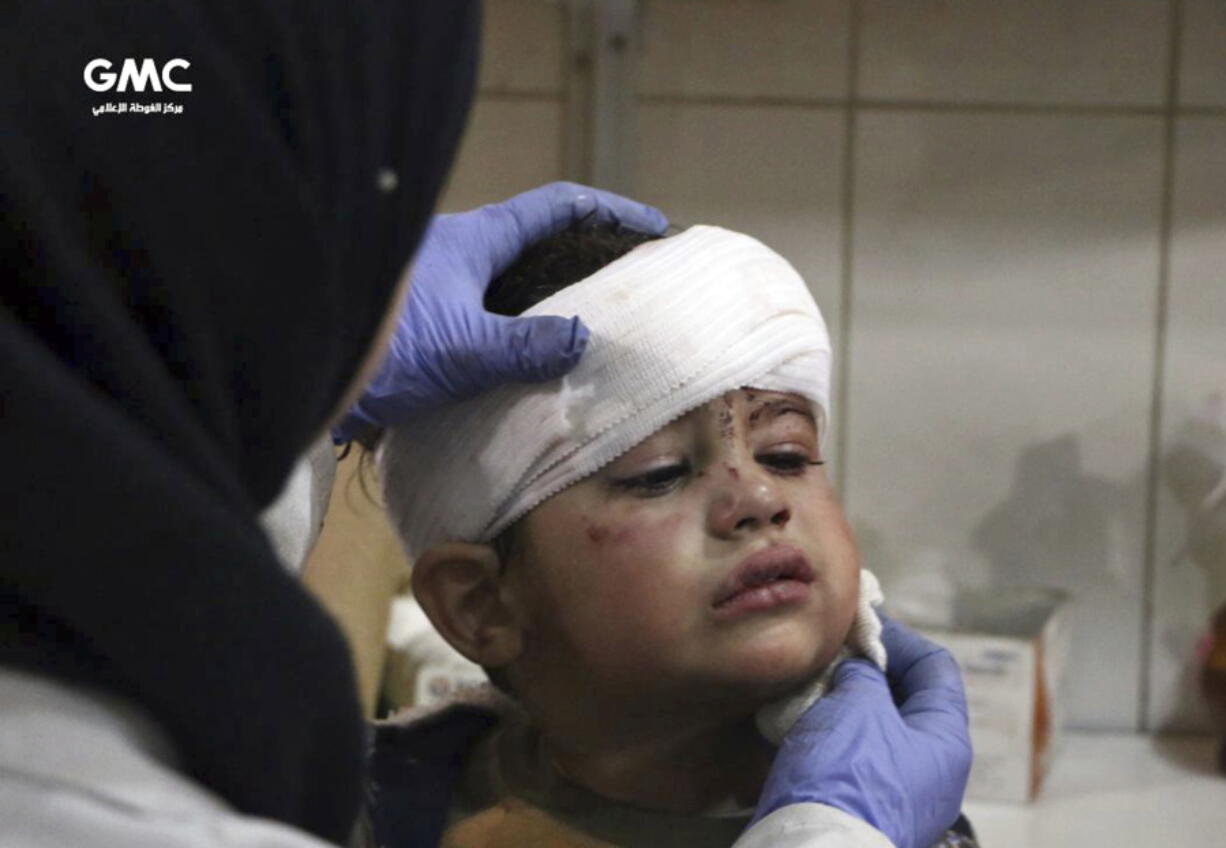 This photo provided by the Syrian anti-government activist group, Ghouta Media Center, GMC, which has been authenticated based on its contents and other AP reporting, shows an injured boy receiving treatment at a hospital in Hazeh in eastern Ghouta, the only remaining rebel stronghold near the capital, Damascus, Syria, Monday, Feb. 5, 2018. The Syrian Observatory for Human Rights says waves of airstrikes hit at least five neighborhoods in the eastern Ghouta suburb.