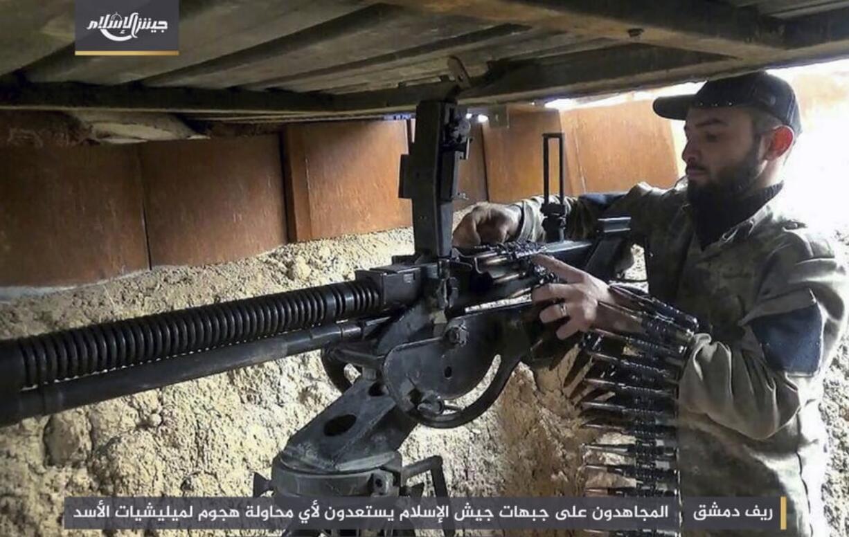 A fighter with the Army of Islam, as he loads a heavy machine gun with bullets, in the suburbs of the Syrian capital Damascus. Many of the fighters entrenched in the Damascus suburb of eastern Ghouta are originally from the area and move around using an elaborate network of underground tunnels, giving them an advantage against President Bashar Assad’s forces and their allies.