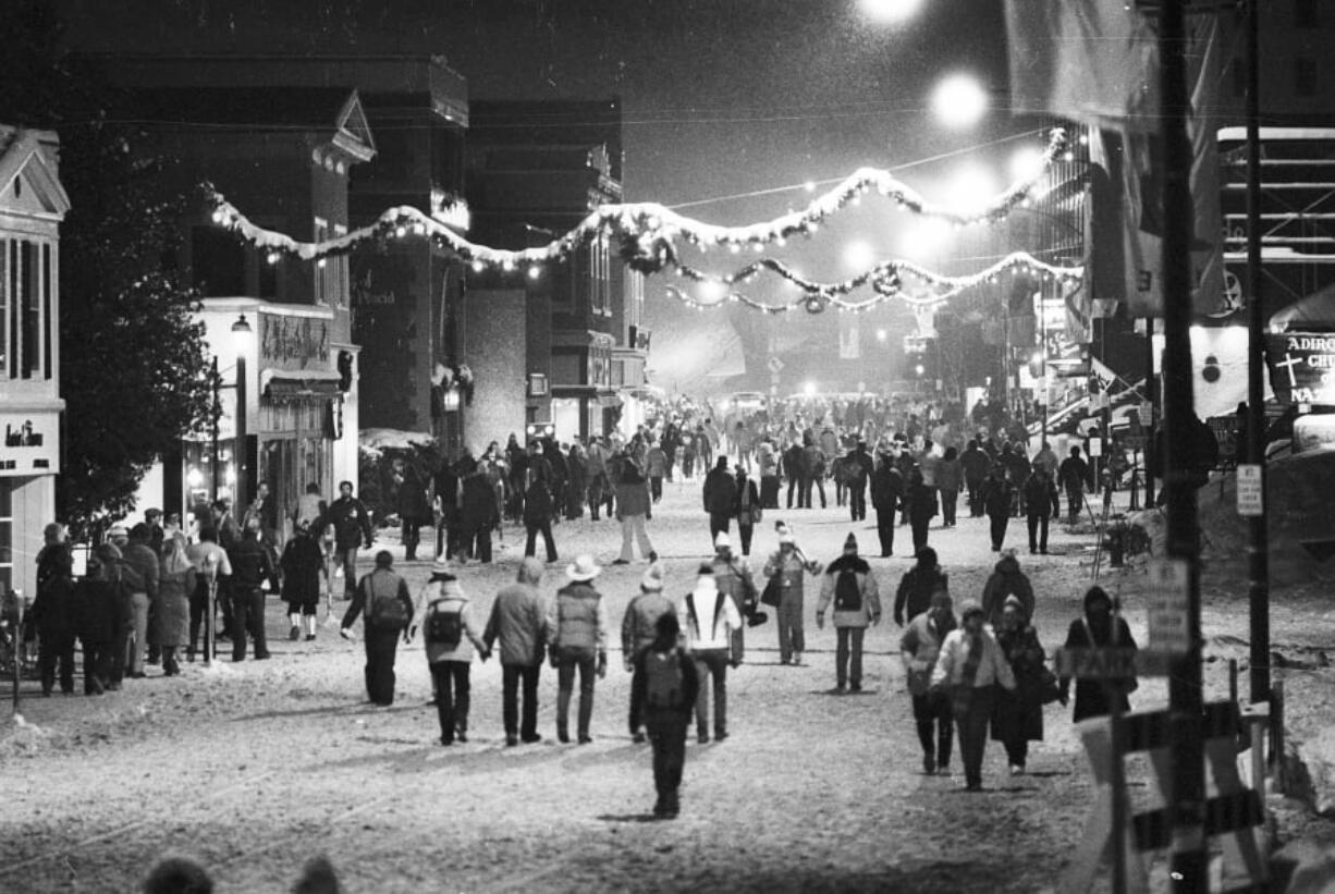 Winter Olympic visitors stroll through the snow-covered downtown area of Lake Placid, N.Y., on Feb. 17, 1980.