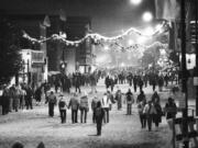 Winter Olympic visitors stroll through the snow-covered downtown area of Lake Placid, N.Y., on Feb. 17, 1980.