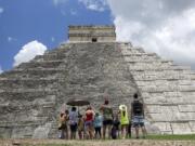 Tourists are dwarfed by El Castillo at the Chichen-Itza ruins July 22, 2016, in Yucatan, Mexico. While beach destinations remain popular for spring break, travel agents say customers are also demanding unique cultural experiences and active outdoorsy adventures.