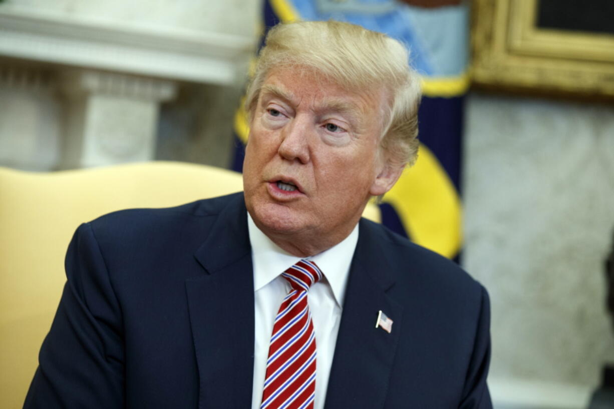 President Donald Trump speaks during a meeting with Shane Bouvet, a campaign volunteer, in the Oval Office of the White House, Friday, Feb. 9, 2018, in Washington.