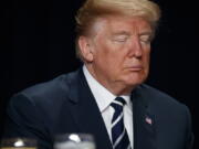 President Donald Trump prays during the National Prayer Breakfast on Thursday in Washington.