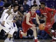 Utah’s Parker Van Dyke, second right, races up the court past Chris Seeley (11) and Washington’s Jaylen Nowell (5) and David Crisp during the first half of an NCAA college basketball game Thursday, Feb. 15, 2018, in Seattle.