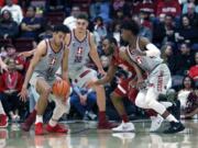 Stanford guard Dorian Pickens (11) steals the ball from Washington State guard Milan Acquaah (5) as Stanford guard Daejon Davis, right, defends during the first half of an NCAA college basketball game Saturday, Feb. 24, 2018, in Stanford, Calif.