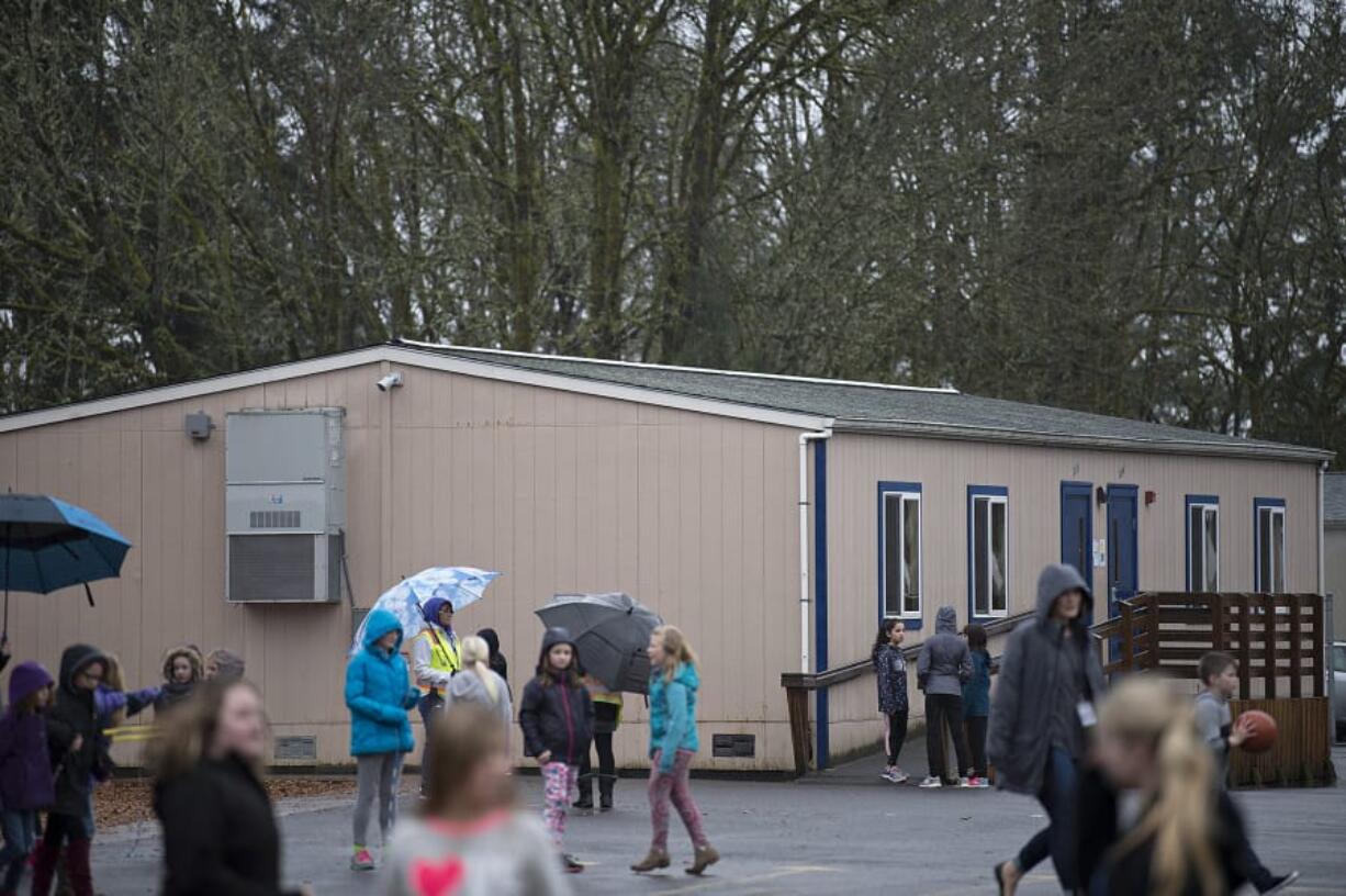 Students play near one of the many portables at La Center School District’s K-8 campus in January. Initial results from Tuesday night’s election show the district’s $48 million bond measure is passing. Most of that money will be used to build a new middle school and transform the K-8 campus into only an elementary school.