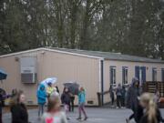 Students play near one of the many portables at La Center School District’s K-8 campus in January. Initial results from Tuesday night’s election show the district’s $48 million bond measure is passing. Most of that money will be used to build a new middle school and transform the K-8 campus into only an elementary school.