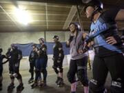 The Storm City Roller Girls discuss strategy before a practice session in Hazel Dell in 2017. The team is hosting a daylong tournament Saturday at the Clark County Event Center at the Fairgrounds. Five out-of-town teams will be participating.