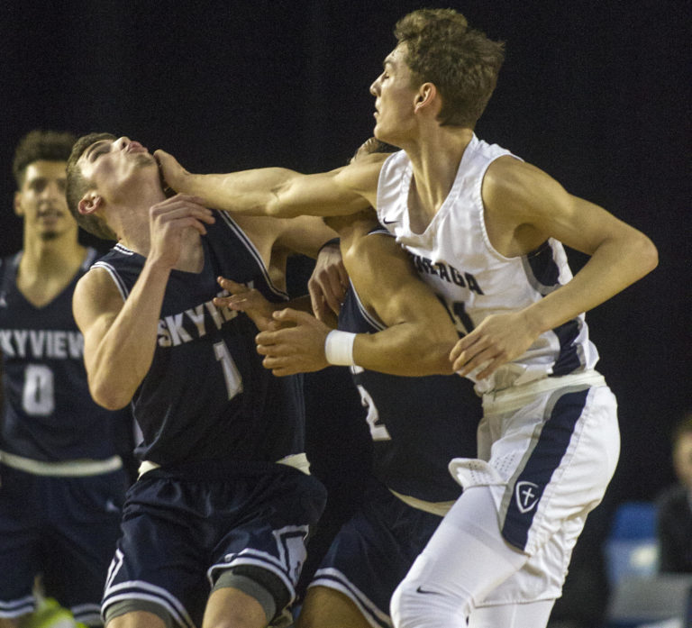 Skyview's Cole Grossman (1) is hit in the face during a rebound by Gonzaga Prep's Liam Lloyd (21) during a WIAA 4A State Hardwood Classic's 2nd round basketball game at the Tacoma Dome on March 1, 2018 in Tacoma.  Gonzaga Prep beat Skyview 59-52.