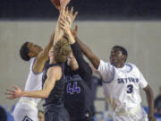 Skyview's Javon Sewell (2) and Samaad Hector (3) battles for a rebound against Kiamak's Conner Fitzpatrick (12) and Ryker Wuttke (44)during a WIAA 4A State Hardwood Classic's consolation basketball game at the Tacoma Dome on March 2, 2018 in Tacoma.  Skyview beat Kamiak 64-56.