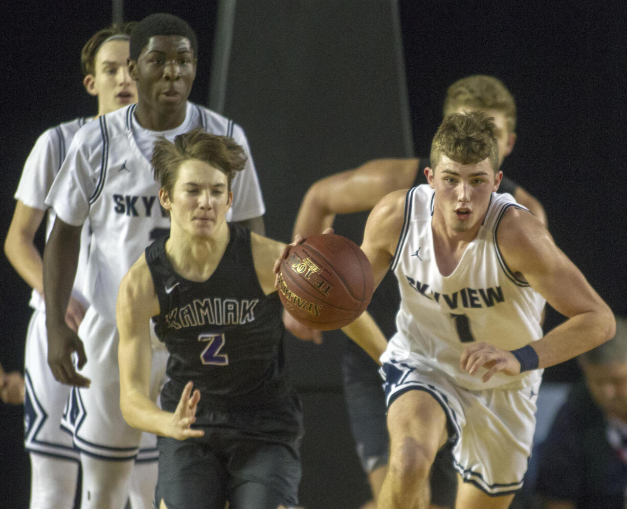 Skyview's Cole Grossman (1) races downcourt followed by Kiamak's Dakota Bueing (2) during a WIAA 4A State Hardwood Classic's 3rd round basketball game at the Tacoma Dome on March 2, 2018 in Tacoma.  Skyview beat Kamiak 64-56.