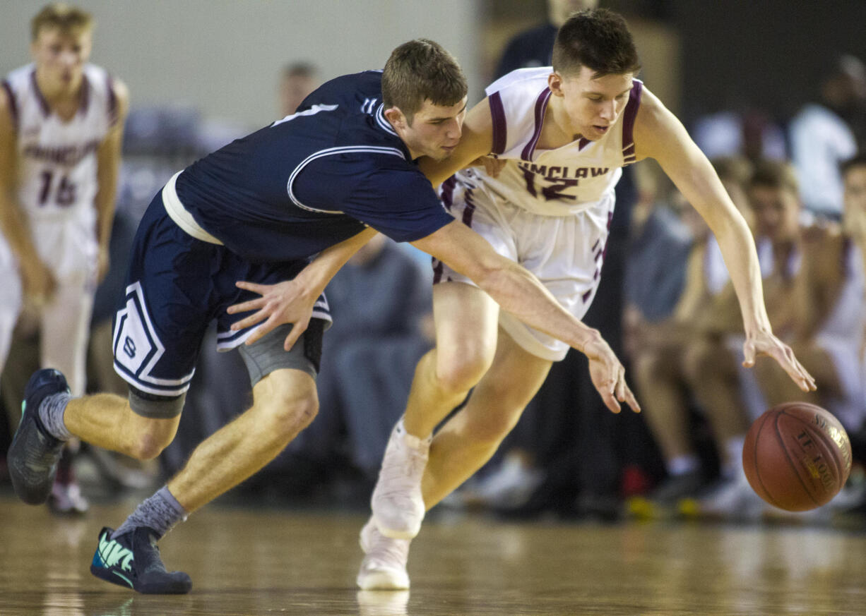 Skyview's Cole Grossman, left, and Enumclaw's Peter Erickson, right, scrambles for a loose ball during the WIAA 4A State Hardwood Classic's fourth and sixth place basketball game at the Tacoma Dome on March 2, 2018 in Tacoma.  Enumclaw beat  Skyview 62-57 to take fourth place.