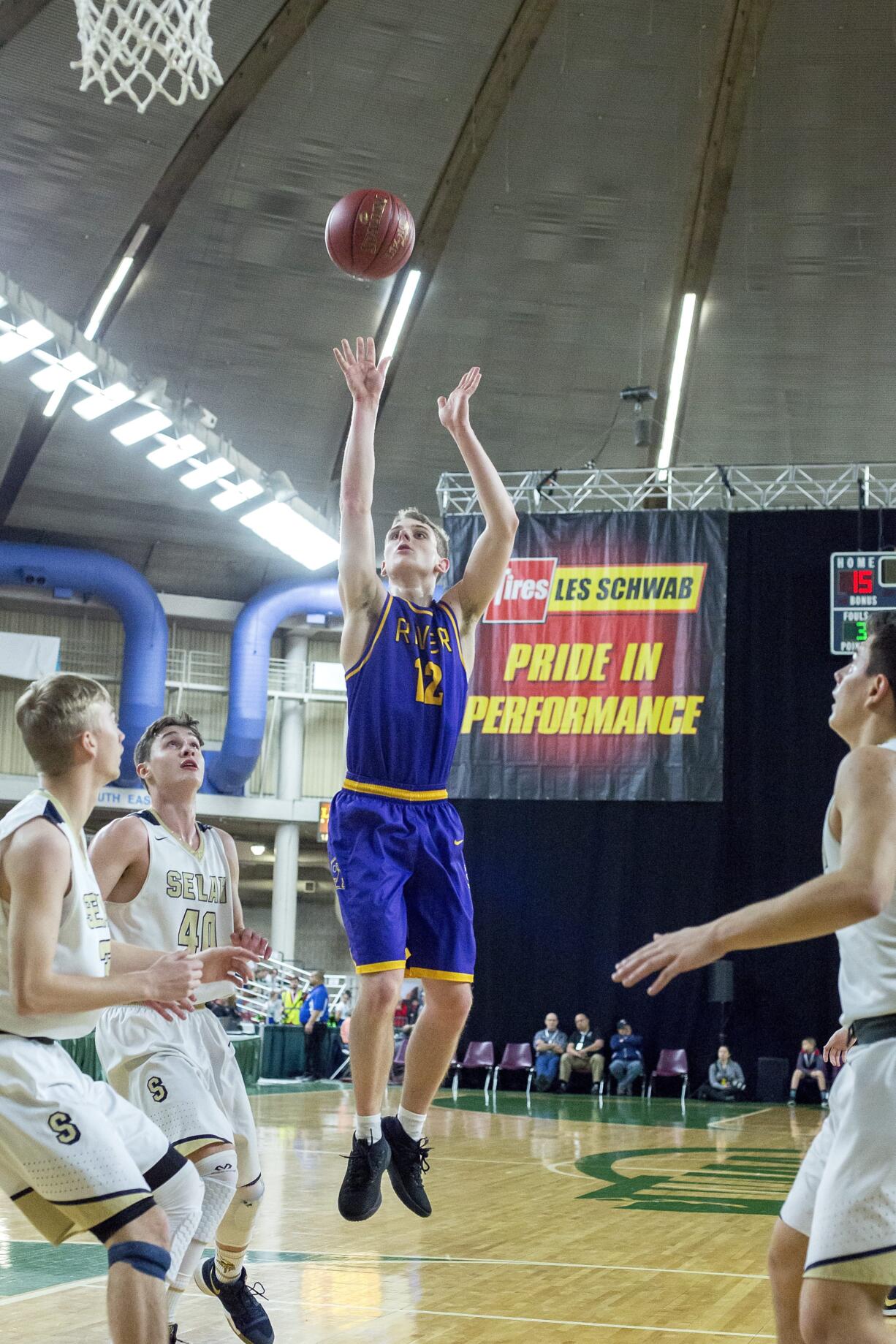 Columbia RiverÕs Jacob Hjort (12) shoots a pull-up jumper over SelahÕs Elijah Pepper (40) in the WIAA 2A boys state basketball tournament on Saturday, Mar. 3, 2018, at the Yakima Valley SunDome. The Columbia River Chieftains took 6th place in state after losing to the The Selah Vikings 58-51.