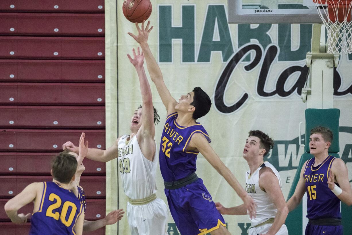 Columbia River’s Nasseen Gutierrez (32) and Selah’s Elijah Pepper (40) reach for a rebound in the WIAA 2A boys state basketball tournament on Saturday, Mar. 3, 2018, at the Yakima Valley SunDome. The Columbia River Chieftains took 6th place in state after losing to the The Selah Vikings 58-51.