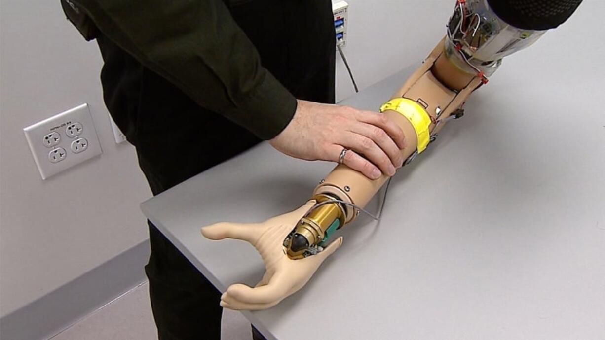 A Cleveland Clinic Lerner Research Institute researcher manipulates a prosthetic arm.