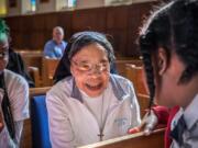 Sister Virginie Fish talks with students from St. Francis International School in Silver Spring, Md., after Mass at the Oblate Sisters of Providence convent in Baltimore.