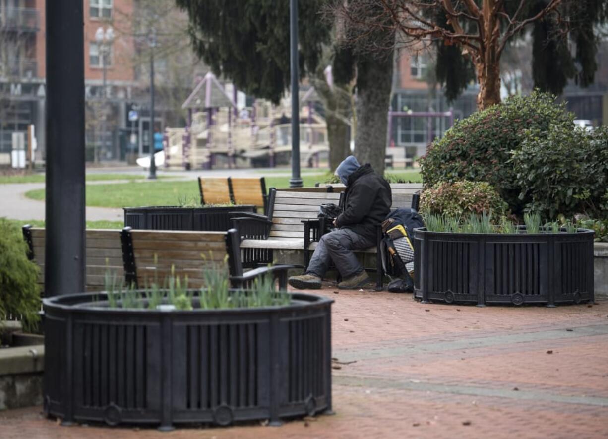 A homeless man, who prefers not to be named, sits on a bench Feb. 8 at Esther Short Park in downtown Vancouver.