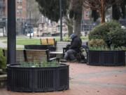 A homeless man, who prefers not to be named, sits on a bench Feb. 8 at Esther Short Park in downtown Vancouver.