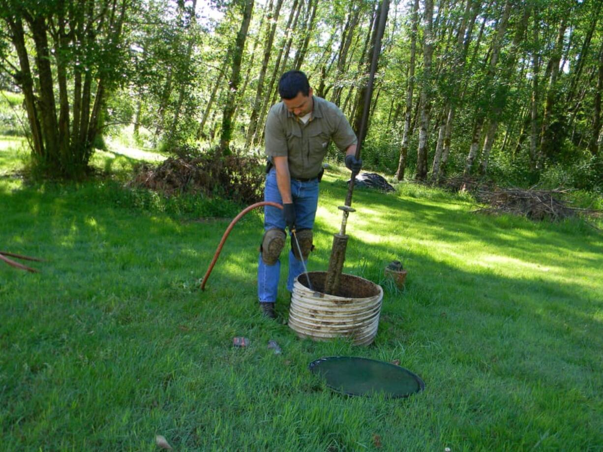 Ronnie Tamez and Chris Gross, two technicians with First Call Septic, perform an inspection on June 21, 2017.