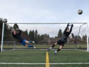 Prairie High School seniors CJ Henry, left, and Tristan Glaser, right, are pictured at practice in Vancouver on Wednesday evening, March 28, 2018. The best friends and fellow goalies have both committed to play at Evergreen State College next year.