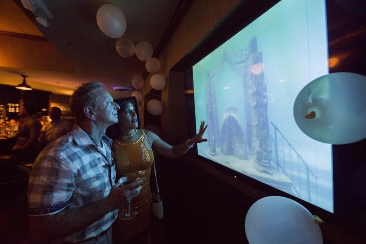 Keith Swirsky and Marianne LaChance Swirsky watch a video of the mausoleum at the Neptune Memorial Reef event to announce the enlargement of the underwater mausoleum 3 miles off Key Biscayne at Smith and Wollensky restaurant, in South Pointe Park, Miami Beach on March 15.