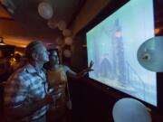 Keith Swirsky and Marianne LaChance Swirsky watch a video of the mausoleum at the Neptune Memorial Reef event to announce the enlargement of the underwater mausoleum 3 miles off Key Biscayne at Smith and Wollensky restaurant, in South Pointe Park, Miami Beach on March 15.