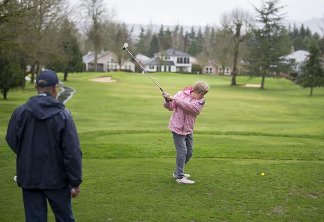 Fairway Village resident Dave Mercer, left, watches as Elaine Saeed tees off on the second hole during a recent golf outing on the Fairway Village course. The 55-and-older community is part a census block group with the oldest median age — 72.6 — in the county.