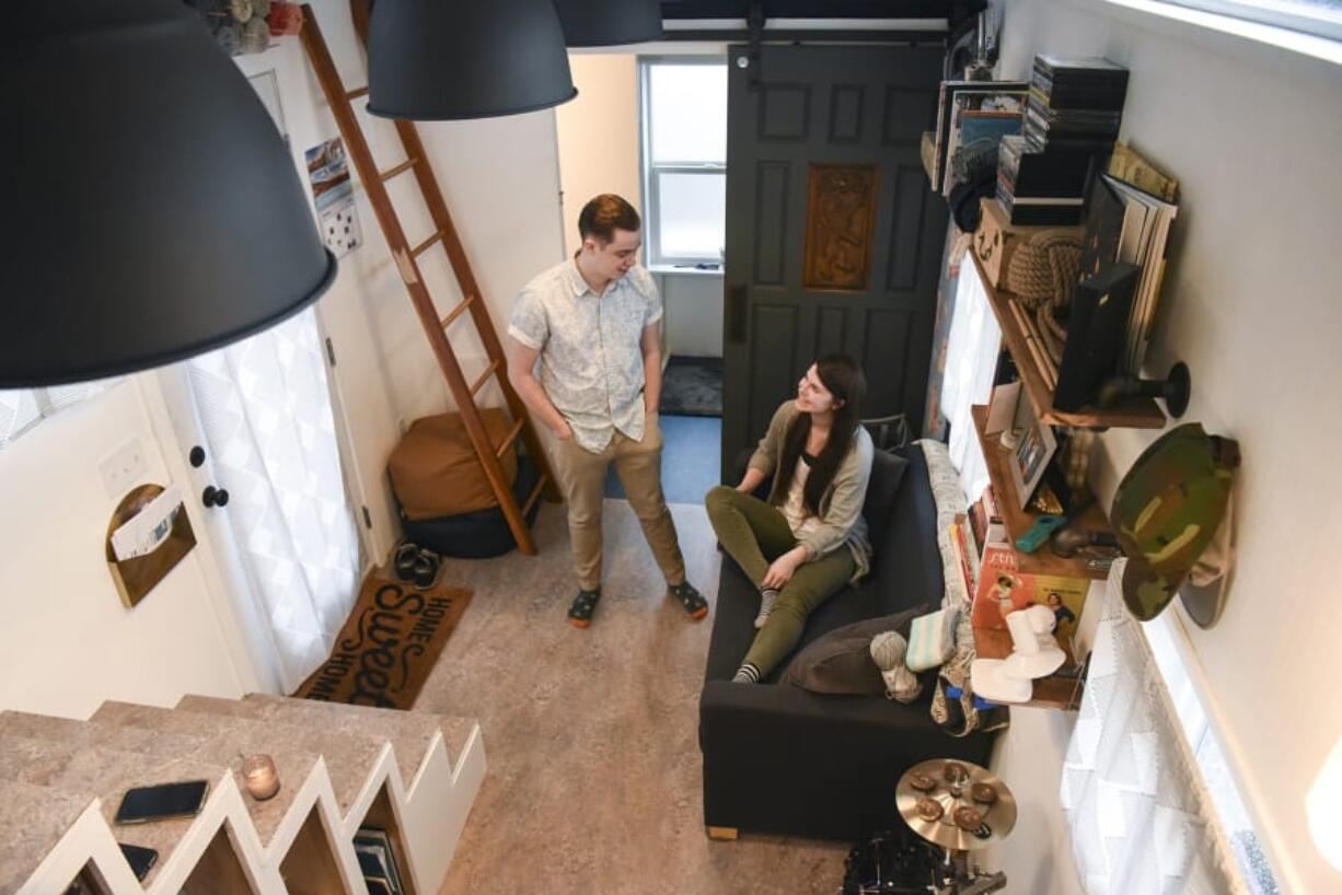 Ethan Woltersdorf, 21, left, and his wife, Morgan Woltersdorf, 22, live in a tiny house in Salmon Creek. The couple, whose tiny house is parked on a family member’s property, recently received a letter from Clark County Code Enforcement telling them their tiny house is not a legal dwelling.