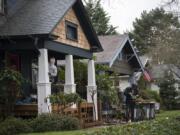 Dann Wynn, left, and J.P. Tugnon of Portland Painting & Restoration work on a home in the Hough neighborhood March 13. The Hough Neighborhood Association is in need of officers after both co-chairs resigned earlier this year.