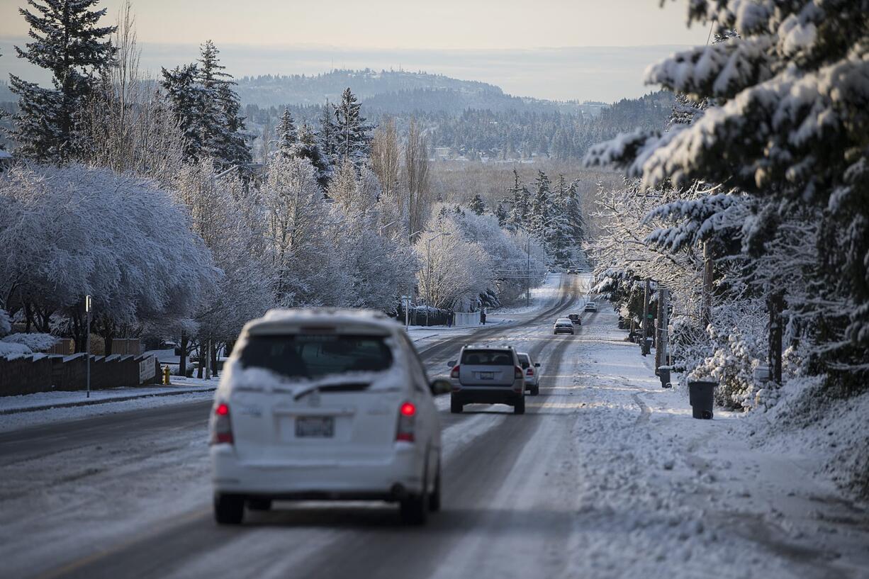 Motorists drive in wintry conditions Feb. 21 on Southeast Ellsworth Road after snow fell overnight.