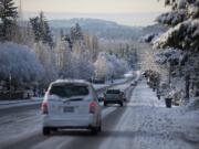 Motorists drive in wintry conditions Feb. 21 on Southeast Ellsworth Road after snow fell overnight.