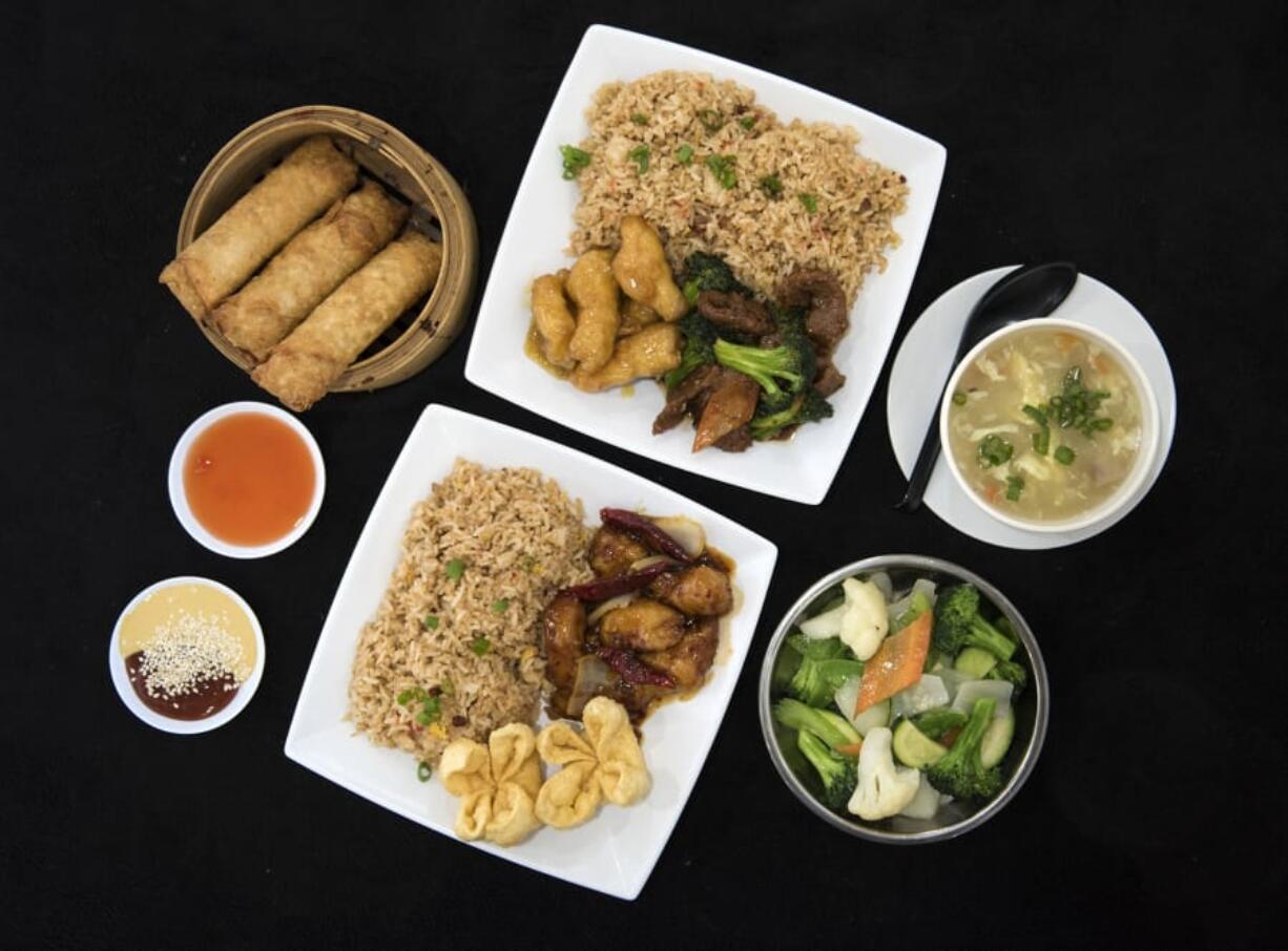 Pork egg rolls, from left, orange chicken, beef broccoli and pork fried rice meal, the egg flower soup, the vegetable deluxe, and the General Tso’s chicken, pork fried rice and crab puff meal are pictured at Blazin Asian Express in Vancouver. Blazin Asian Express offers dine in, take out and delivery.