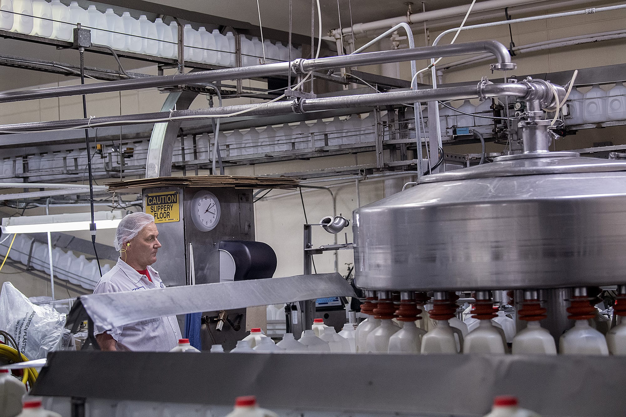 Richard Gaylor, longtime employee of Andersen Dairy, keeps an eye on gallons of two percent milk while working at the dairy's Battle Ground headquarters Tuesday afternoon, Feb. 27, 2018. Ron Andersen, founder of Andersen Dairy and Andersen Plastic in Battle Ground, died Feb. 10. He originally started his plant in 1966, and it's still one of the biggest employers in the city.