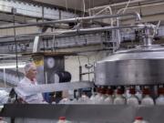 Richard Gaylor, longtime employee of Andersen Dairy, keeps an eye on gallons of 2 percent milk while working at the dairy’s Battle Ground headquarters, which opened in 1966 after Ron Andersen purchased the processing plant. Andersen, who died Feb. 10, went on to open three plastics plans, a trucking company and grocery store.