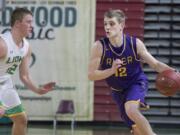 Columbia River's Jacob Hjort (12) drives past Lynden's Brock Heppner (12) during the WIAA 2A boys state basketball tournament on Thursday, Mar. 1, 2018, at the Yakima Valley SunDome. Lynden Lions defeated Columbia River Chieftains 44-33.