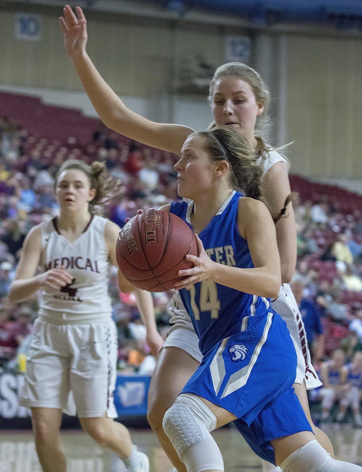 La Center's Bethany Whitten (14) drives past Medical Lake's Jaxyn Farmen (20) before making a pass during the WIAA 1A girls state basketball tournament on Thursday, Mar. 1, 2018, at the Yakima Valley SunDome. Medical Lake Cardinals defeated La Center Wildcats 41-31.