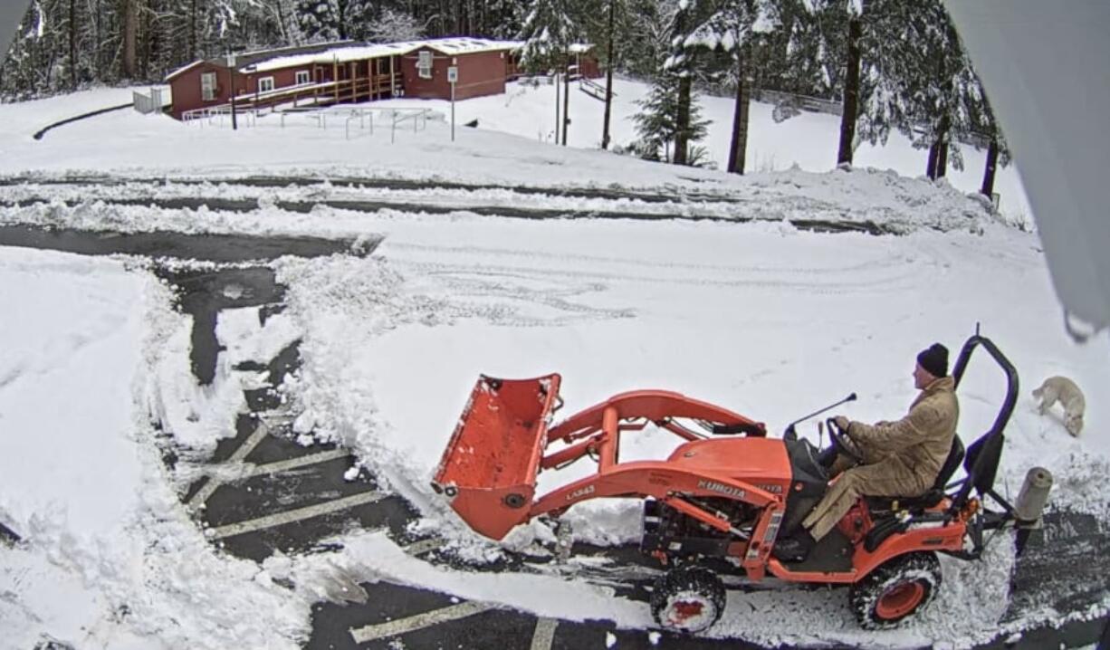 Woodland: Tyson Vogeler, superintendent of Green Mountain School District, plows the school campus early Feb. 21, as captured by the school district’s security cameras.