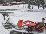 Woodland: Tyson Vogeler, superintendent of Green Mountain School District, plows the school campus early Feb. 21, as captured by the school district’s security cameras.