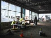 Terry Koker, left, and Brandon Koumaros of R. Miller Construction look over plans for WildFin American Grill inside the restaurant. The restaurant officially took occupancy Monday at The Waterfront Vancouver. It is expected to open in August.