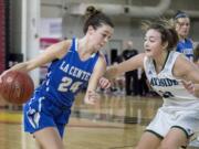 La Center's Taylor Stephens (24) drives through Lakeside's Maiya Martinez (22) committing a foul in the WIAA 1A girls state basketball tournament on Friday, March 2, 2018, at the Yakima Valley SunDome.