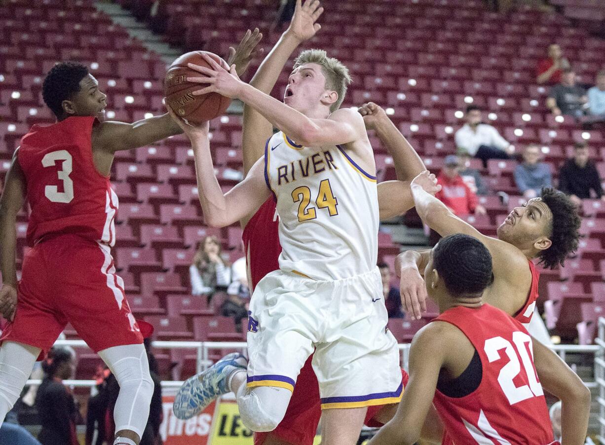 Columbia River's Jack Armstrong (24) cuts through Renton's defense to the hoop in the WIAA 2A boys state basketball tournament on Friday, Mar. 2, 2018, at the Yakima Valley SunDome. Columbia River Chieftains defeated the Renton Indians 64-44.