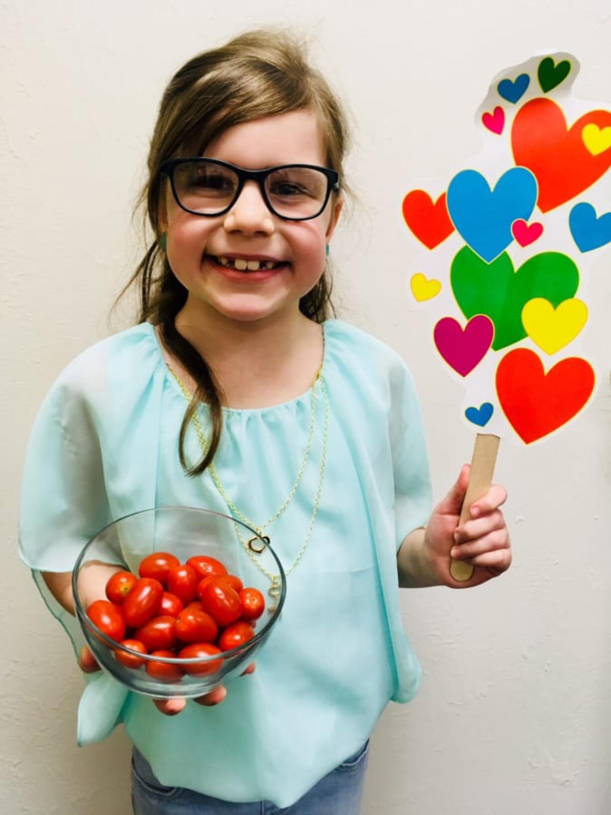 Fircrest: Cecily Lambert, a second-grader at Fircrest Elementary School, with a bowl of cherry tomatoes she called “cheery tomatoes” as part of a challenge to re-name fruits and vegetables during Washington State University Extension’s Supplemental Nutrition Assistance Program Education’s Harvest of the Month program.