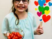 Fircrest: Cecily Lambert, a second-grader at Fircrest Elementary School, with a bowl of cherry tomatoes she called “cheery tomatoes” as part of a challenge to re-name fruits and vegetables during Washington State University Extension’s Supplemental Nutrition Assistance Program Education’s Harvest of the Month program.