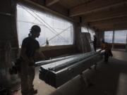 Brandon Neville of Harlens Drywall, foreground, works with colleagues at the upcoming Home Depot QuoteCenter headquarters on Columbia House Boulevard. Though it and other developments are sweeping through Clark County, builders say they are building more cautiously due to rising construction costs and an inevitable downturn on the horizon.