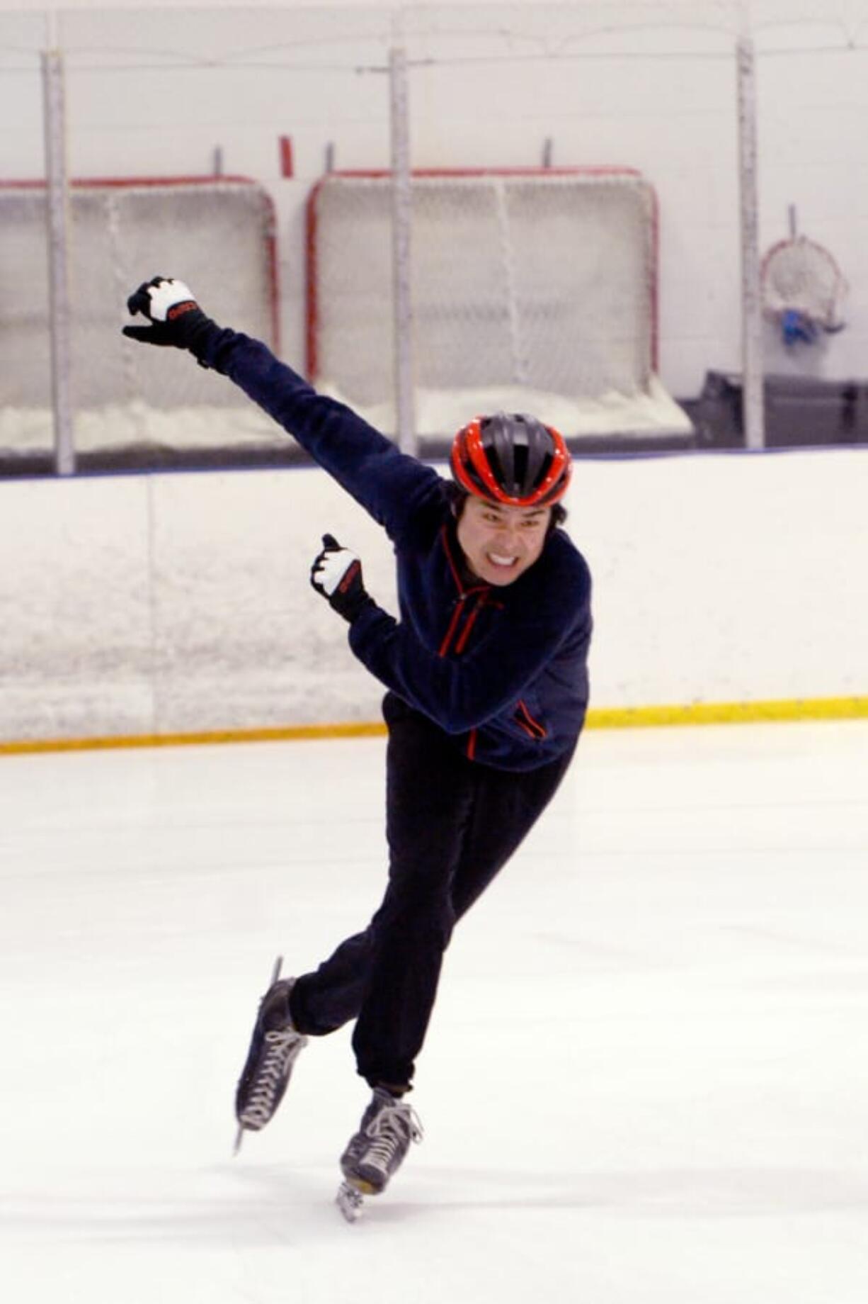 Mark Shimahara grimaces while sprinting during a speed skating drill Sunday at Mountain View Ice Arena as part of a practice session with the Mountain View Speedskating Club.