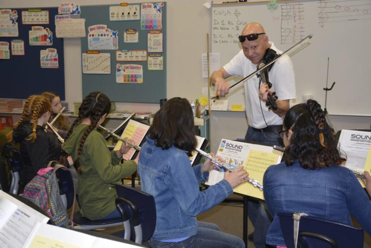 Washougal: Rob Pullen, a parent in the Washougal School District, performed with his violin with Gause Elementary School students.