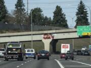 Graffiti is visible on the railroad crossing just south of Exit 4 on Interstate 5 in Vancouver on Monday. Washington Department of Transportation crews have increased their cleanup work this year, dealing with graffiti in 137 locations since January.