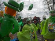 Lauren Graham, center, and Alexi Resoff of the Vancouver School District's GATE Program get into the spirit of the annual Paddy Hough Parade as they prepare to leave Hough Elementary School on Friday. The pair were two of hundreds of participants that celebrated the Saint Patrick's Day holiday in style.